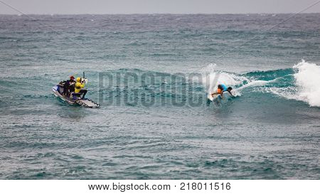 SUNSET BEACH HAWAII USA - DECEMBER 2, 2017: Surf patrol filming surfer competing at the 2017 Vans World Cup of Surfing competition at Sunset Beach on Oahu's scenic North Shore. This is the second of three surfing competitions and Conner Coffin took first 