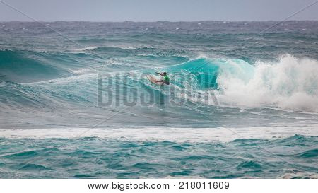 SUNSET BEACH HAWAII USA - DECEMBER 2, 2017: Surfer competing at the 2017 Vans World Cup of Surfing competition at Sunset Beach on Oahu's scenic North Shore. This is the second of three surfing competitions and Conner Coffin took first place.