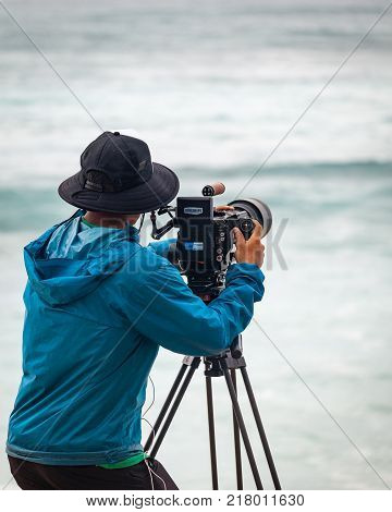 SUNSET BEACH HAWAII USA - DECEMBER 2, 2017: Videographer at the 2017 Vans World Cup of Surfing competition at Sunset Beach on Oahu's scenic North Shore. This is the second of three surfing competitions and Conner Coffin took first place.
