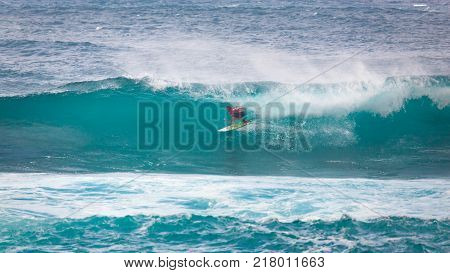 SUNSET BEACH HAWAII USA - DECEMBER 2, 2017: Surfer entering barrel of wave at the 2017 Vans World Cup of Surfing competition at Sunset Beach on Oahu's scenic North Shore. This is the second of three surfing competitions and Conner Coffin took first place.