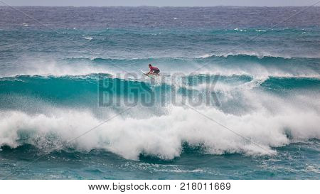 SUNSET BEACH HAWAII USA - DECEMBER 2, 2017: Surfer competing at the 2017 Vans World Cup of Surfing competition at Sunset Beach on Oahu's scenic North Shore. This is the second of three surfing competitions and Conner Coffin took first place.