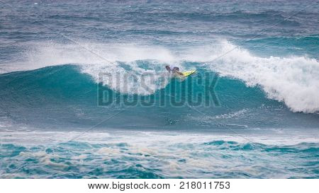 SUNSET BEACH HAWAII USA - DECEMBER 2, 2017: Surfer competing at the 2017 Vans World Cup of Surfing competition at Sunset Beach on Oahu's scenic North Shore. This is the second of three surfing competitions and Conner Coffin took first place.