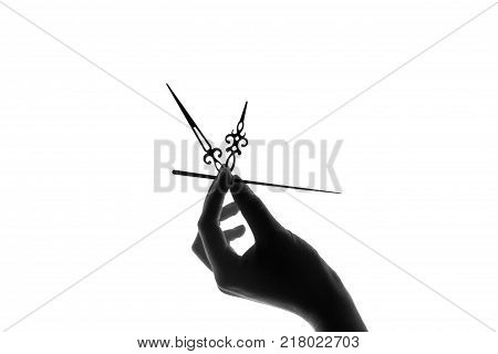 silhouette of a clock in a young female hand on white background. Time, time is in your hands, priceless concept.
