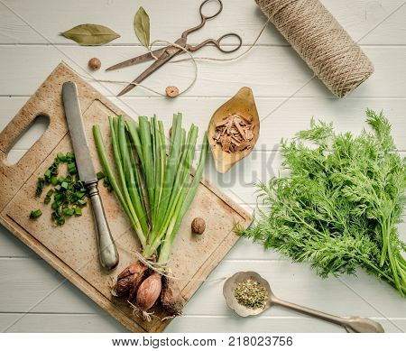 Green onion, dill on the cutting board, topshot