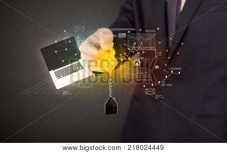 Businessman in suit holding keys with statistics, graphs and icons around