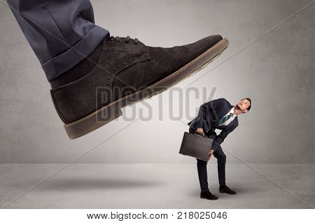 Young businessman illustrated inconsiderable by being trampled