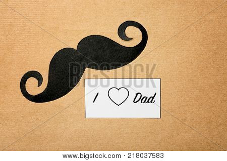 Composition with phrase I LOVE DAD for Father's Day on craft paper