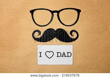 Composition with phrase I LOVE DAD for Father's Day on craft paper