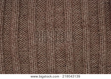 Texture of brown knited scarf with ornament
