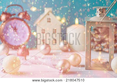 Christmas Composition Lantern House Candle Holder Balls Ribbon Pine Cone Vintage Clock Five Minutes to Midnight New Year Countdown Sparkling Garland Confetti Lights Pastel Blue Background