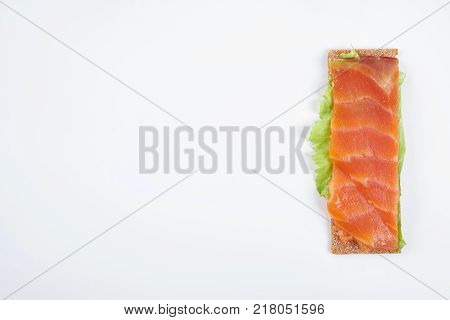 Low caloric open sandwich with red fish. Isolated on white background.