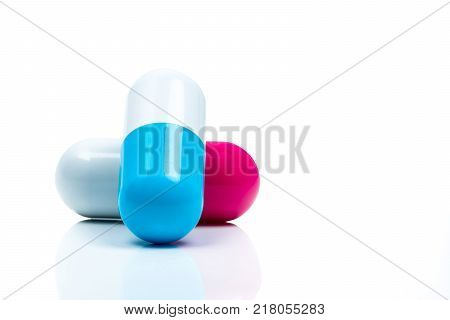 Two capsule pills isolated on white background. Global healthcare concept.