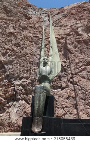 NEVADA, USA - June 30, 2017: Metal Statue at the Hoover Dam. The Hoover Dam is at the Stateline of Nevada and Arizona