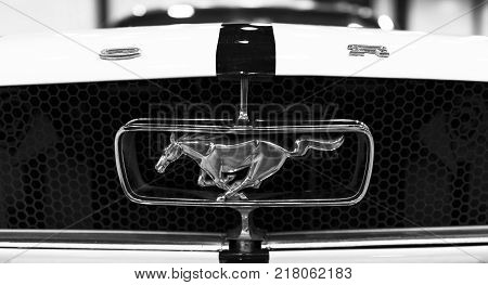 Sankt-Petersburg Russia July 21 2017: Front view of Classic retro Ford Mustang GT logo with running horse. Car exterior details. Black and white. Photo Taken at Royal Auto Show July 21