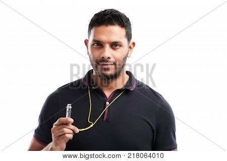 Waist-up portrait of handsome bearded soccer coach wearing polo shirt looking at camera with confident smile while holding whistle in hand, isolated on white background