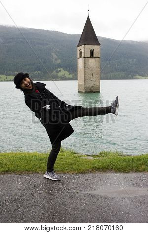 Traveler Asian Thai Woman Travel And Posing For Take Photo At Submerged Tower Of Reschensee Church D
