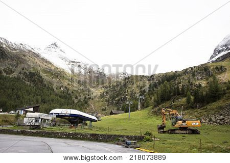 Excavator loader or backhoe machinery waiting works outdoors at construction site in otztal alps mountain of Schnals city on September 2 2017 in Bolzano Austria