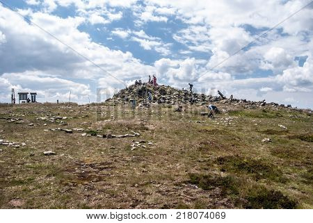 Kralicky Sneznik (Snieznik) hill summit on czech - polish borders during summer day with blue sky and clouds