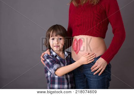 Beautiful Preschool Child, Hugging His Pregnant Mom