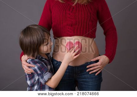 Beautiful Preschool Child, Hugging His Pregnant Mom