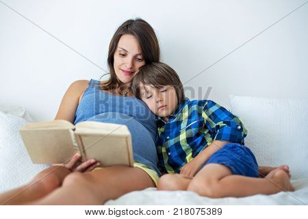 Beautiful Preschool Child, Hugging His Pregnant Mom
