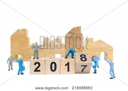 Miniature people : Worker team building wooden block number 2018 isolated on white background