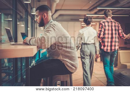 Young independent speacialists in coworking office.