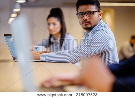 Young independent speacialists in coworking office.