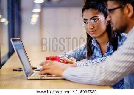 Young independent speacialists in coworking office.