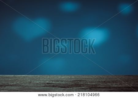 Empty brown wood table top on blue background with white transparent hearts. Used for display or montage your products.
