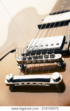 CLOSE UP OF SEMI ACOUSTIC ELECTRIC GUITAR