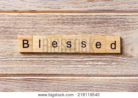 Blessed word written on wood block. Blessed text on table concept.