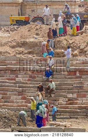 HAMPI, KARNATAKA, INDIA, MARCH 26, 2015: building of sacred pool in the Kailash , Kailasanatha temple. The use of female labor in India. The process of construction.