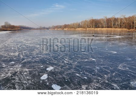 Ice of frozen lake in sunny weather
