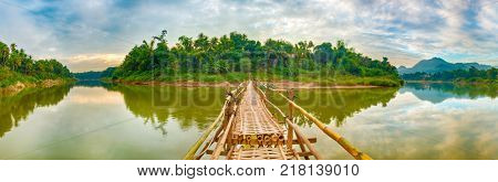 Beautiful view of a bamboo bridge. Luang Prabang. Laos landscape. Panorama