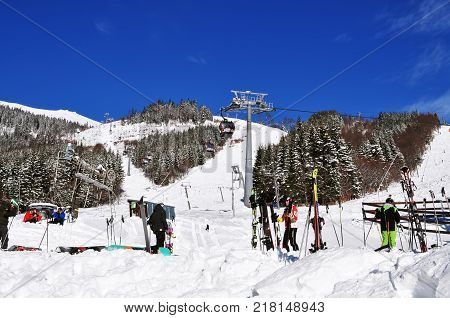 Jasna Slovakia - December 1 2017: Skiers cableway and snow slopes on the south side of Mount Chopok on a sunny day in the ski resort Jasna Low Tatras Slovakia.