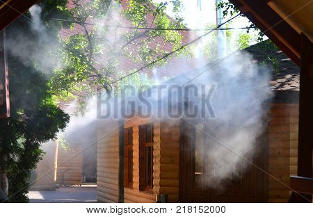 Irrigation system close-up. Humidification of air by steam on the street outdoor in a hot summer day morning