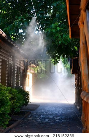 Irrigation system close-up. Humidification of air by steam on the street outdoor in a hot summer day morning