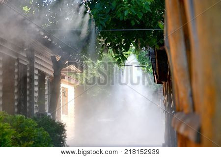 Irrigation system close-up. Humidification of air by steam on the street outdoor in a hot summer day morning