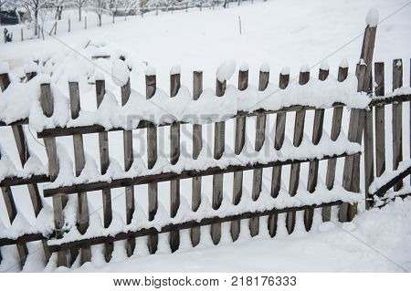 Country fence full of snow