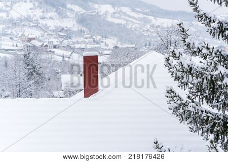 Houses roof under winter snow
