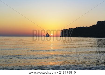 the yacht goes to sea towards the sunrise. a beautiful view of the Mediterranean Sea and the beautiful bay. top view