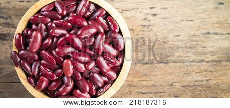 Red bean kidney in a bowl on wooden background top view banner panoramic crop for copy space Red bean. Red bean on table.