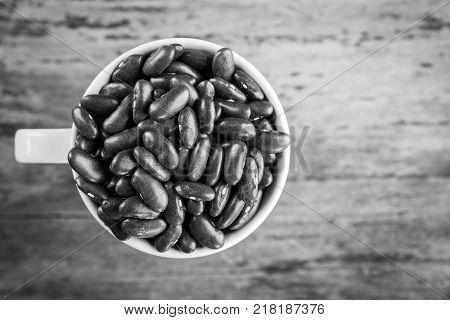 Red bean kidney in cup on wooden background top view Red bean. Red bean on table.