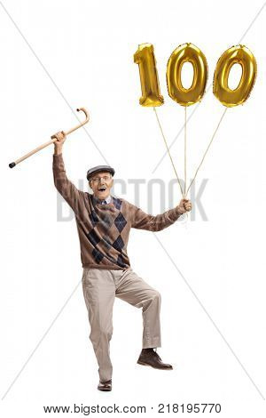 Full length portrait of an overjoyed senior with a cane and a golden number hundred balloon isolated on white background