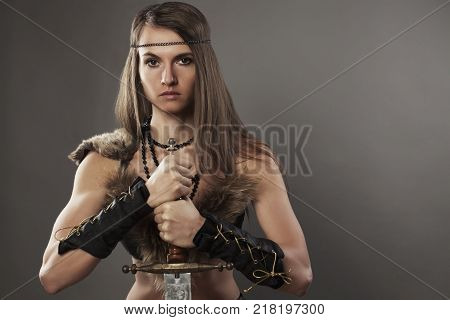 Woman Amazon With Sword On Dark Bg Studio Shot