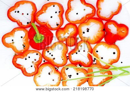 Sliced bolgarian paprika red and yellow pepper and black pepper peases