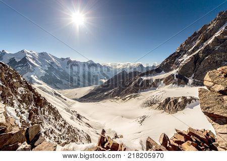 Beautiful view of the mountains from Peak Sella altitude 4300 meters visiting card of the Central Caucasus, Russia. Sunny weather and cloudless blue sky.