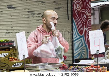 TEL AVIV , ISRAEL - 21 NOVEMBER 2017: Sellers on the old grocery street Nahalat-Benjamin