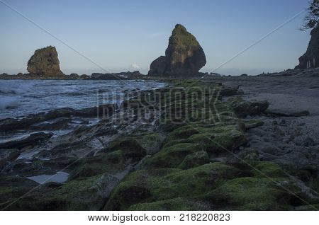 INDONESIA: Scenery of Tanjung Papuma Beach with rock and mossy foreground. Papuma beach is located at Jember,Surabaya, East Java.